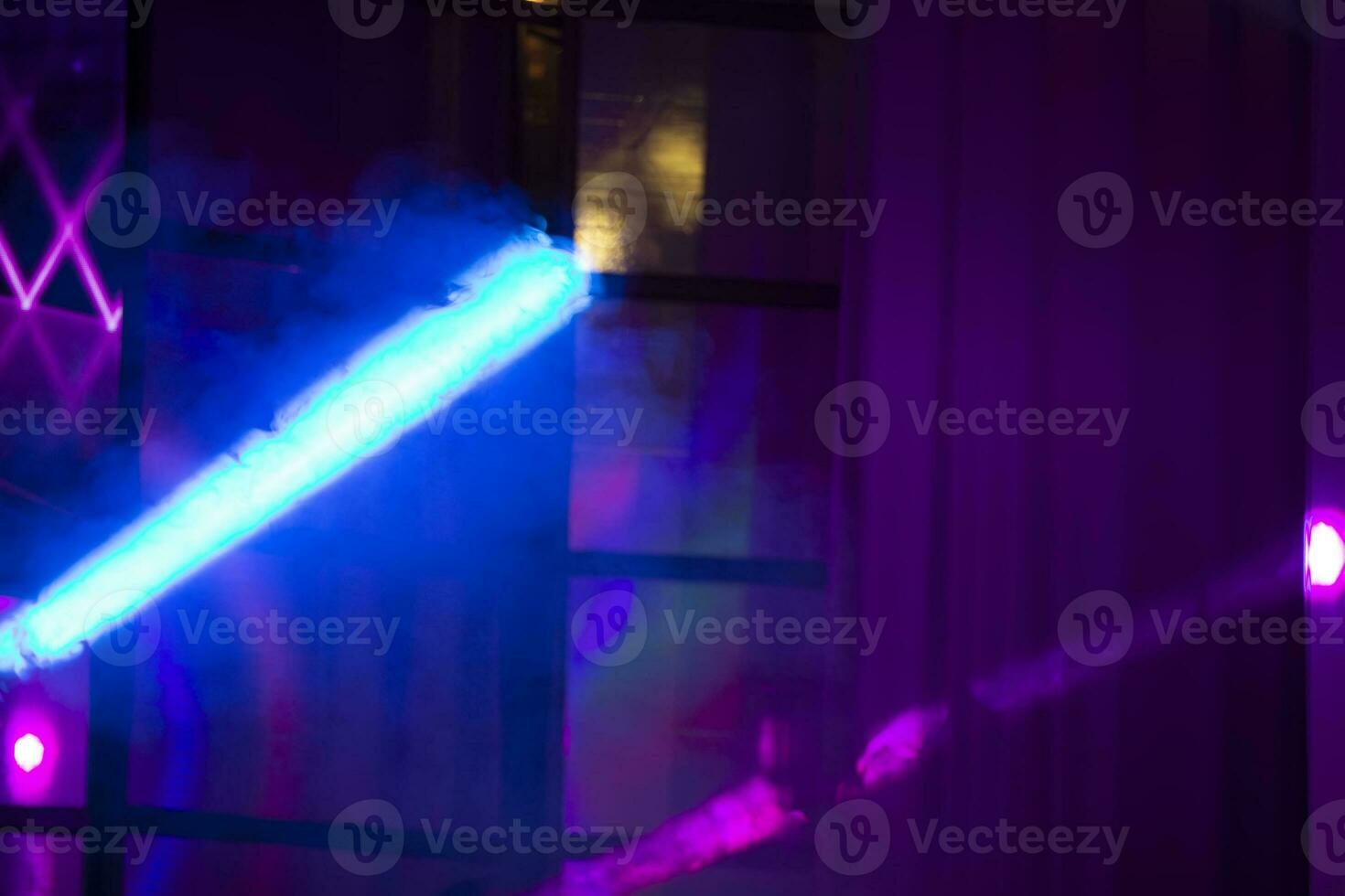 Multicolored rays of light from a stage spotlight on a blue background. photo