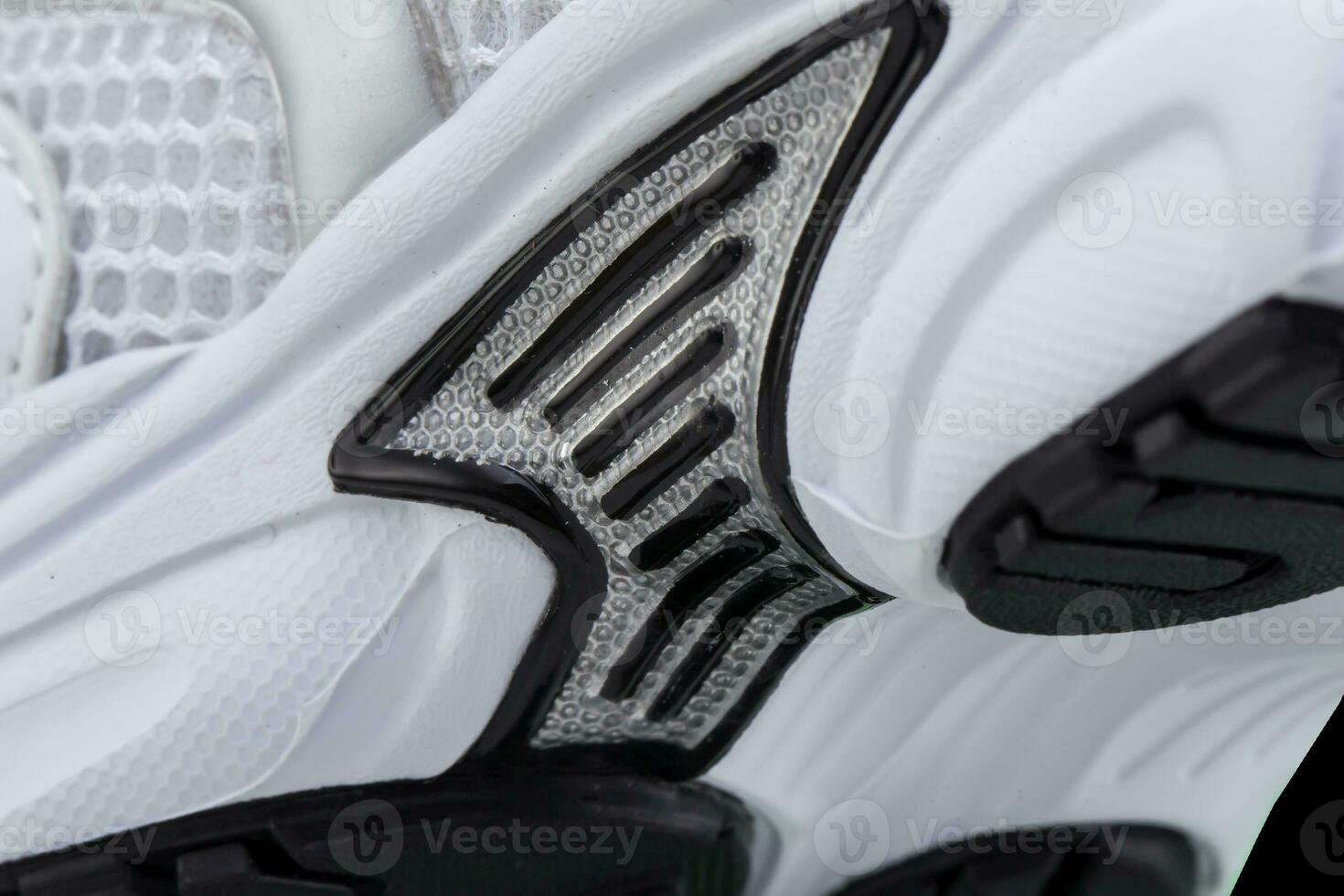 Fragment of a rubber black and white sole of a sneaker. Bottom of sports shoes photo
