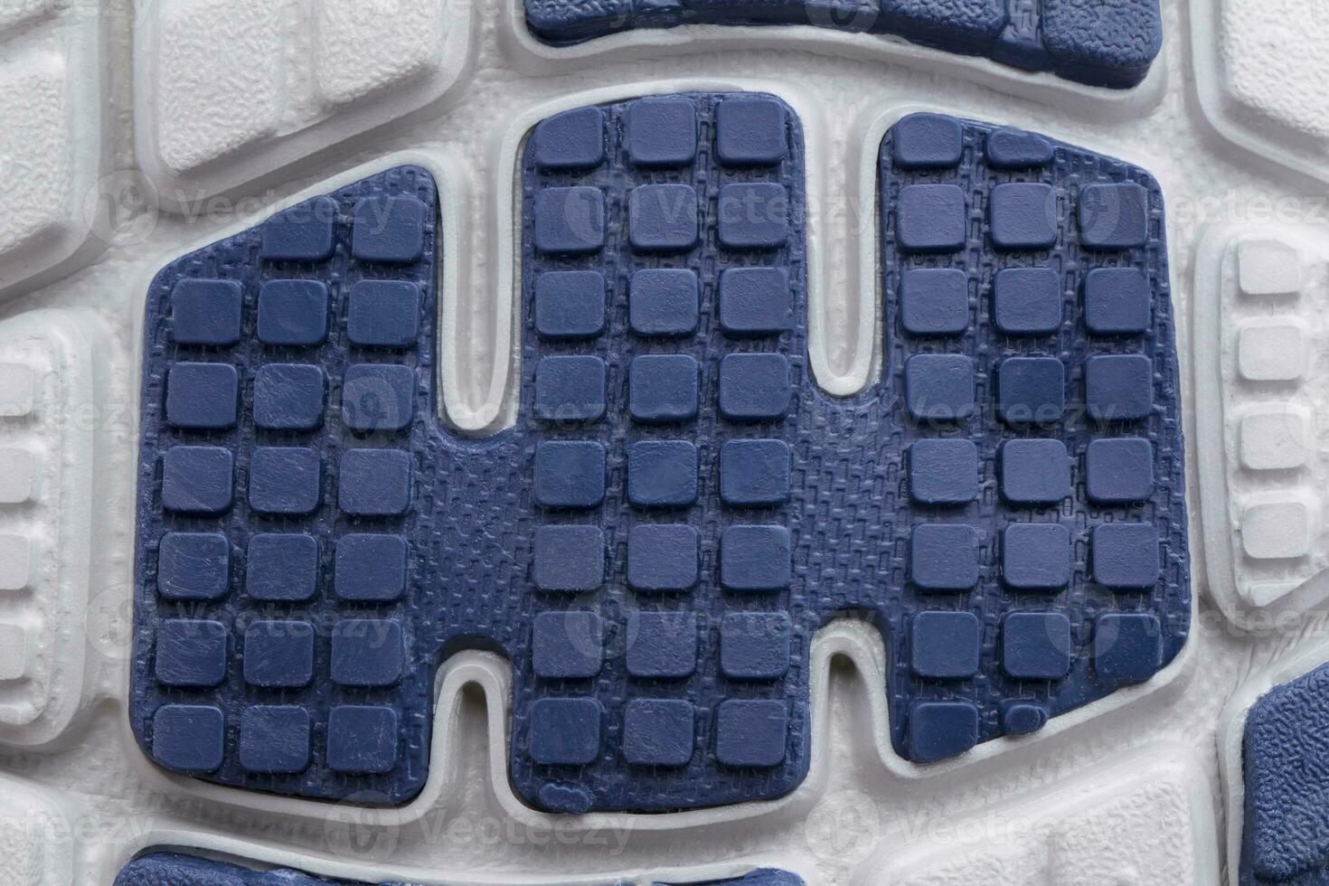 Fragment of a rubber blue-white sole of a sneaker. Bottom of sports shoes photo
