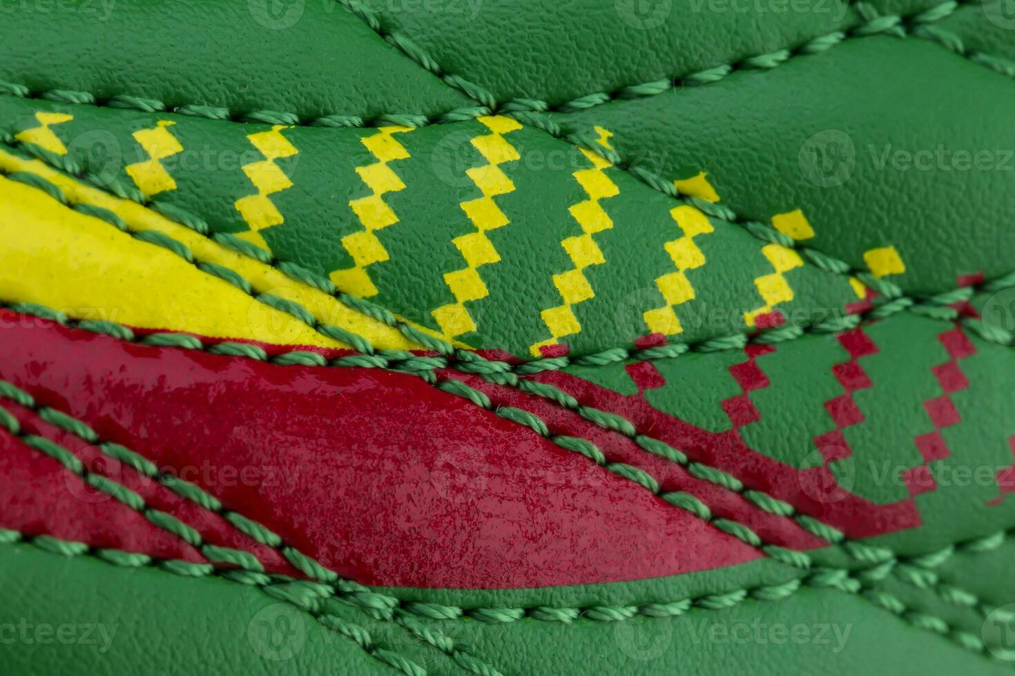 Fragment of a green-red sneaker. The texture of the material of sports shoes photo