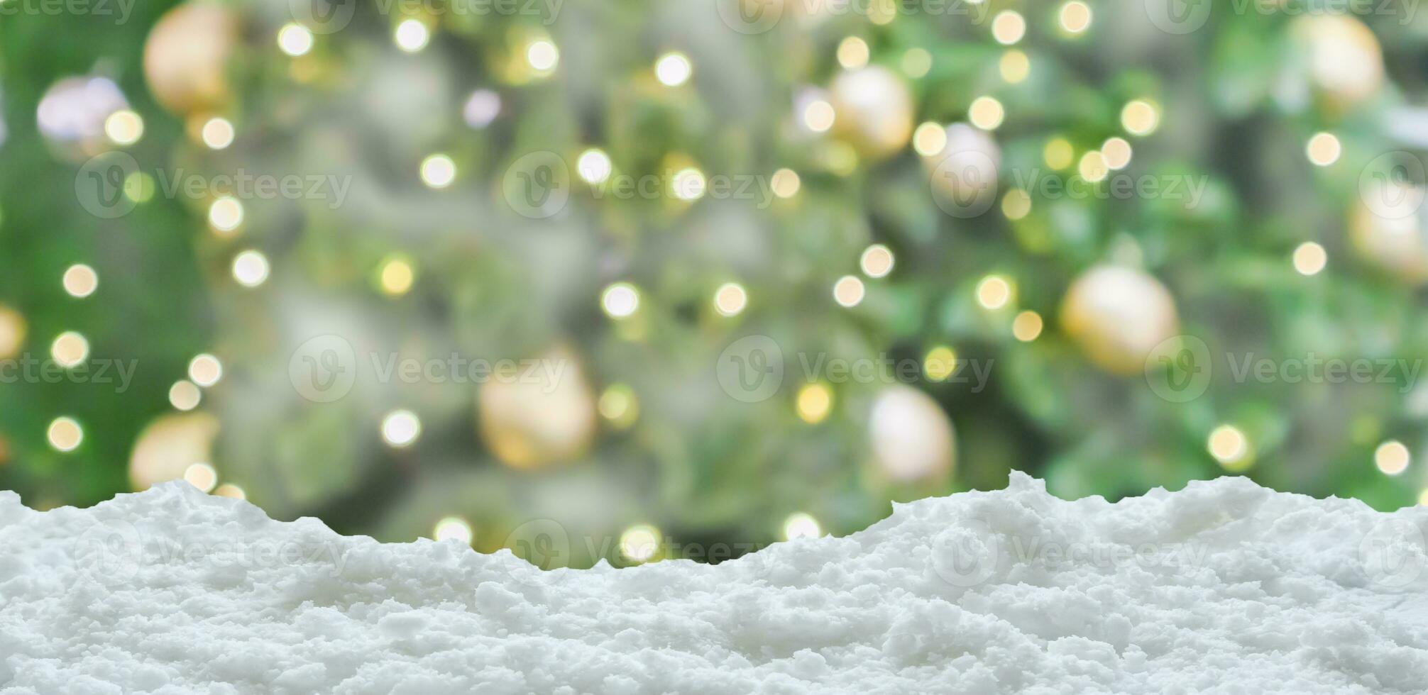 Empty white snow with blur Christmas tree with bokeh light background photo