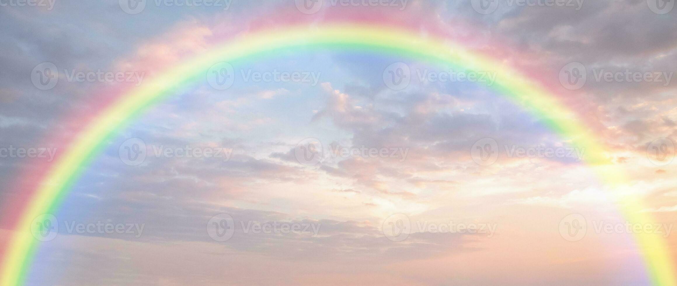 Beautiful rainbow with clouds and blue sky photo