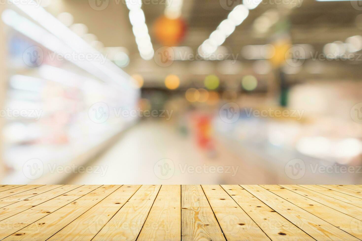Empty wood table top with supermarket blurred background for product display photo