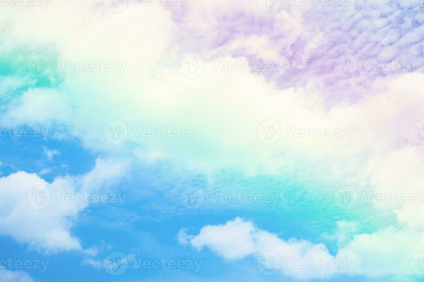Beautiful rainbow pastel color with clouds and blue sky photo