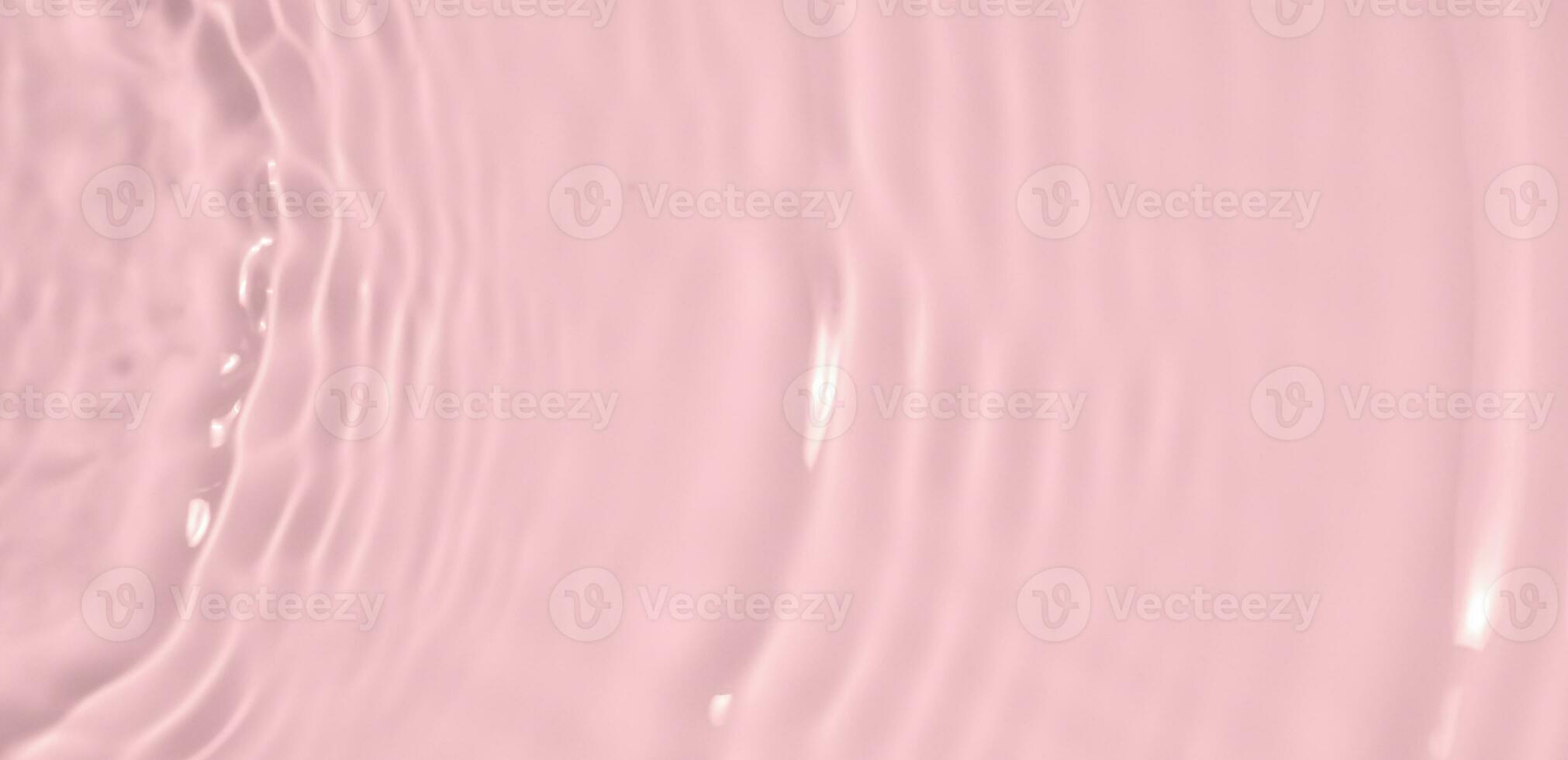 Abstract transparent water shadow surface texture natural ripple on pink background photo