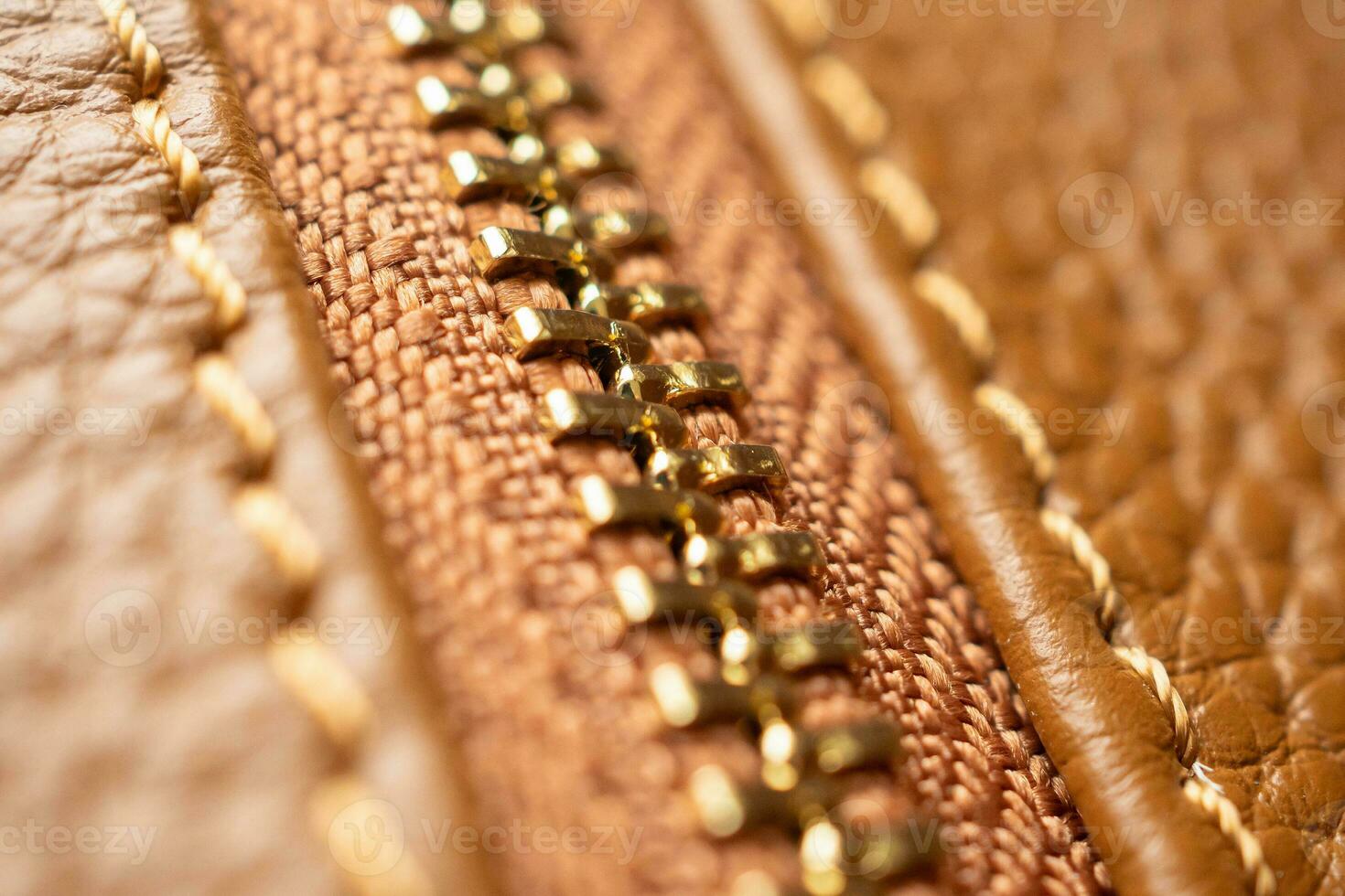 close up of zipper on brown leather bag photo