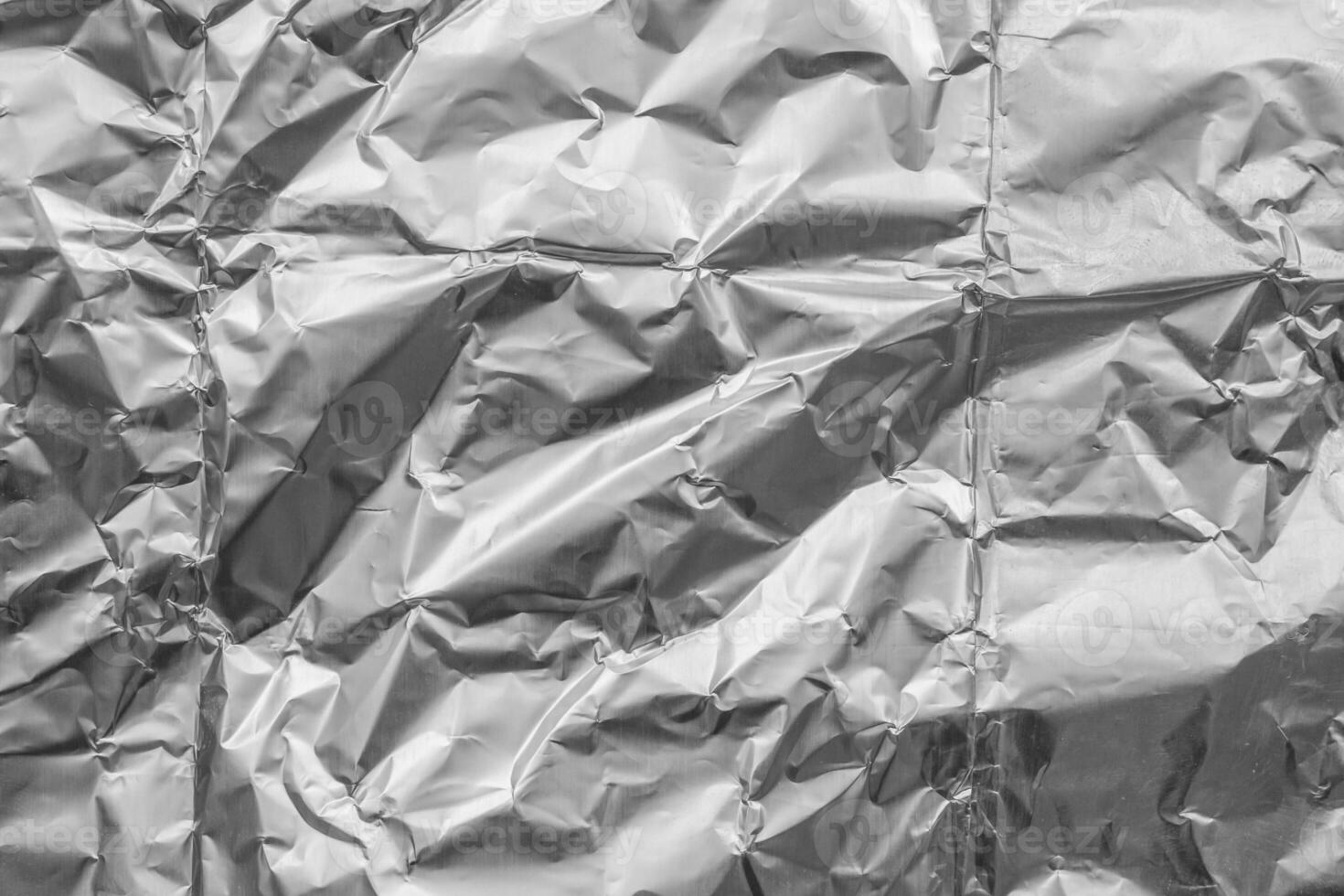 Shiny metal silver gray foil crumpled texture background photo