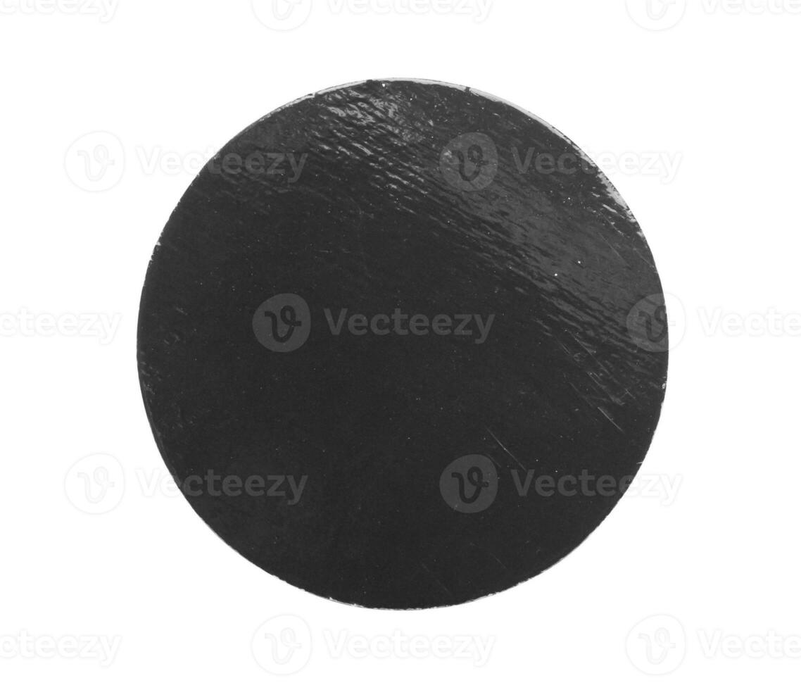 Black old scratched round paper sticker isolated on white background photo