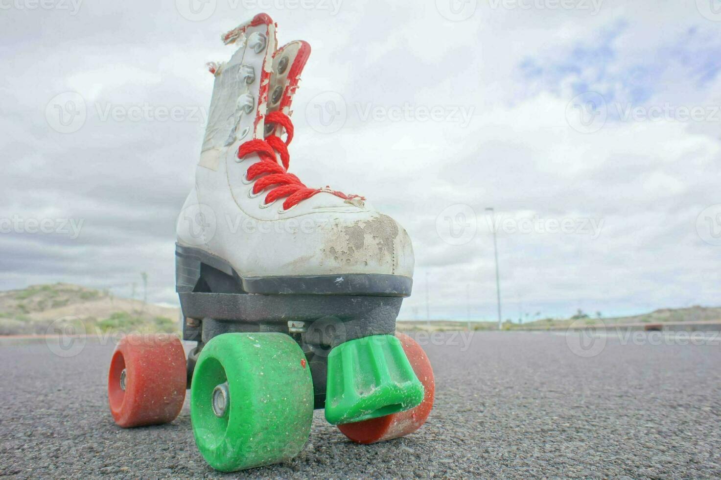 an old roller skate with red and green wheels photo