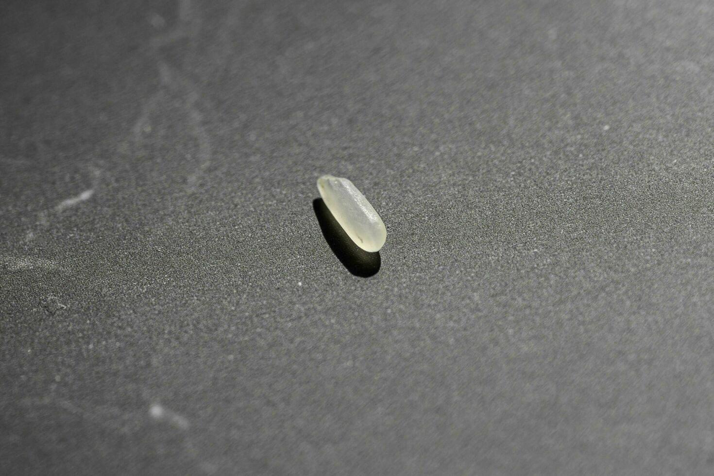 Close up of uncooked rice grains on black background. Healthy food concept. photo
