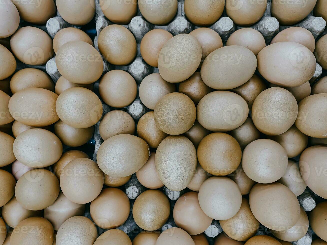 Top view of chicken eggs on a cardboard tray. Food background. photo