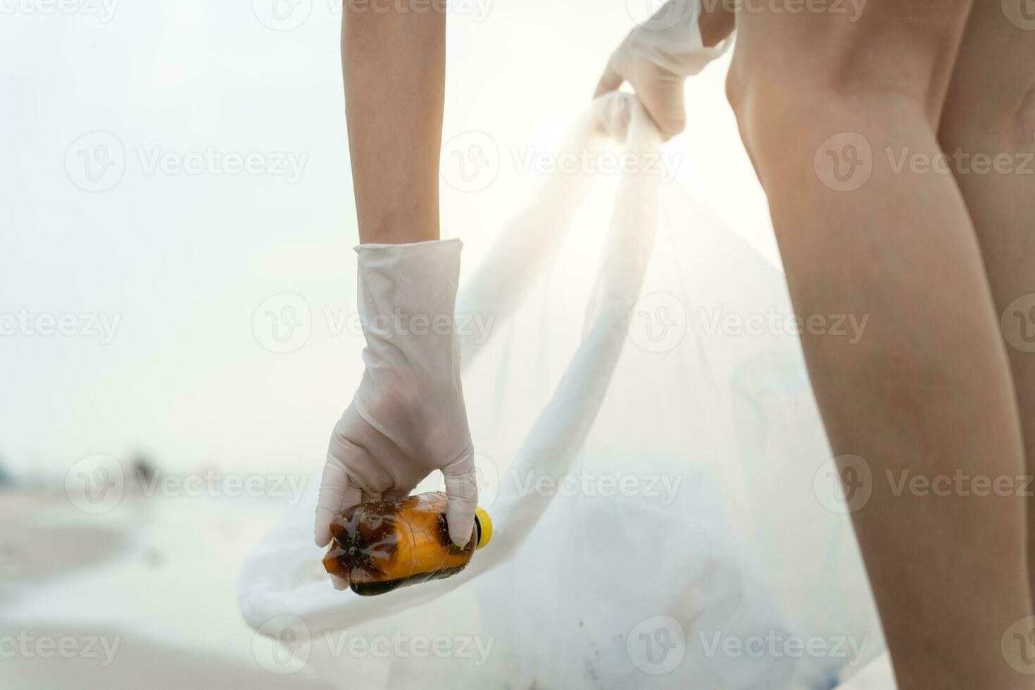 Save water. Volunteer pick up trash garbage at the beach and plastic bottles are difficult decompose prevent harm aquatic life. Earth, Environment, Greening planet, reduce global warming, Save world photo