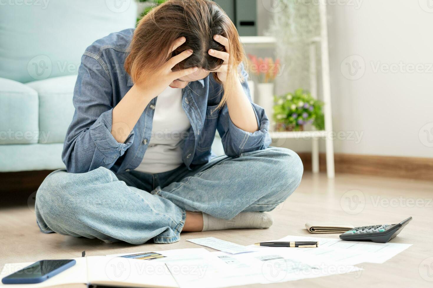 Stressed and headache asian woman with large bills or invoices no money to pay to expenses and credit card debt. shortage, Financial problems, mortgage, loan, bankruptcy, bankrupt, poor, empty wallet photo