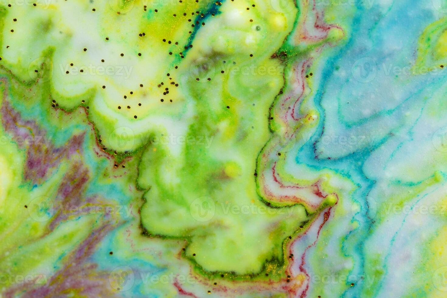 Multicolored colorful background of yellow and green paints in the form of a wave covered with gold sparkles. photo