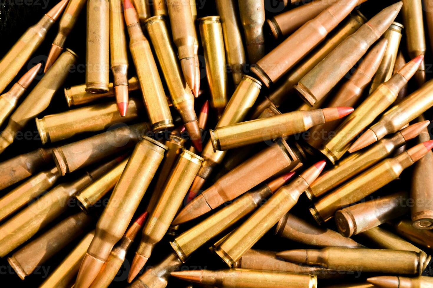 Old sniper bullets pile on dark background, soft focus, new edited, concept for shooting sports and training to protect human life and property around the world. photo