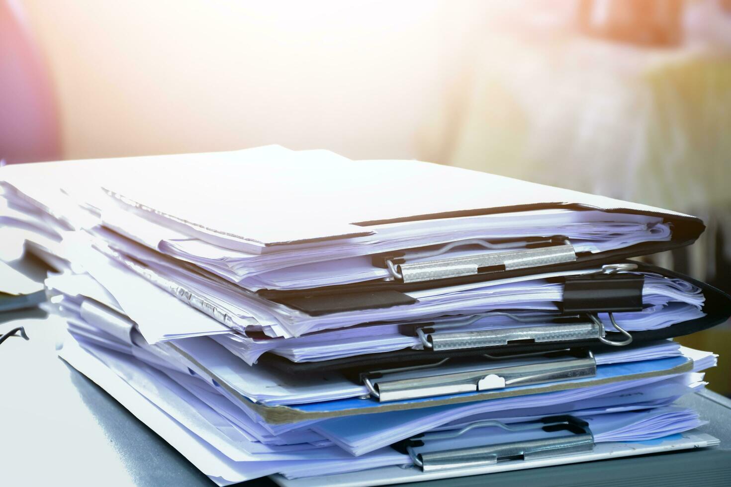 Stack of documents on table of secretary, sunlight edited, soft and selective focus. photo