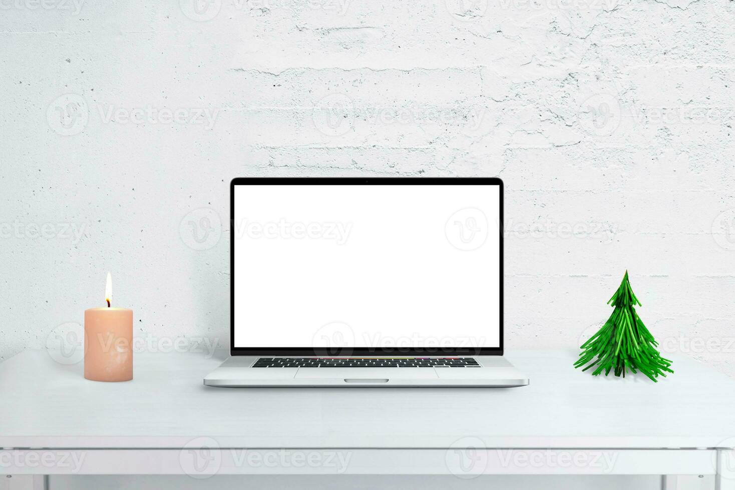 Laptop mockup on desk with Christmas decor, tree, and calendar. Cozy holiday office scene for seasonal greetings and productivity. photo