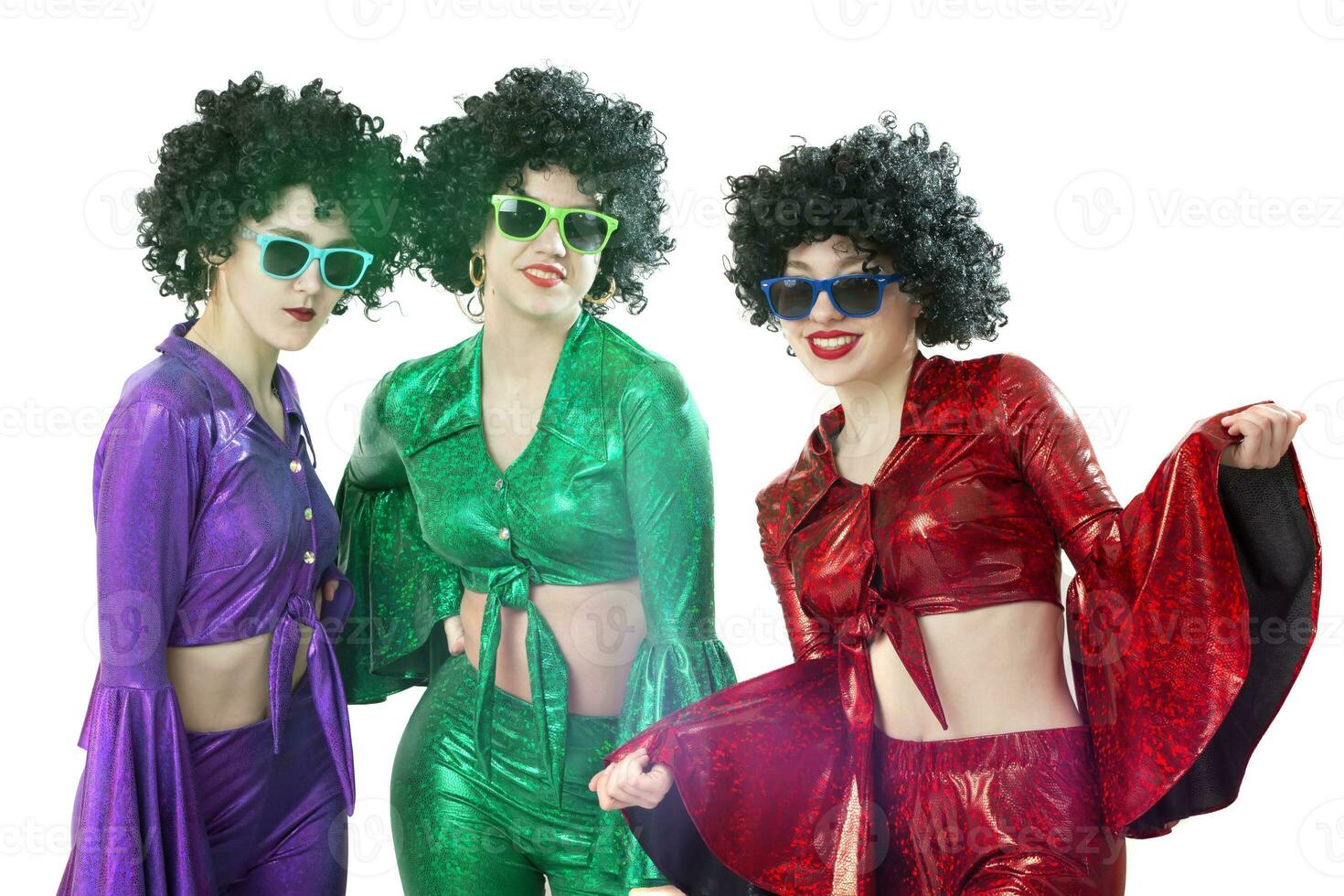 Disco style girls in colorful flared suits and African American wigs on a white background. Seventies or eighties style. photo