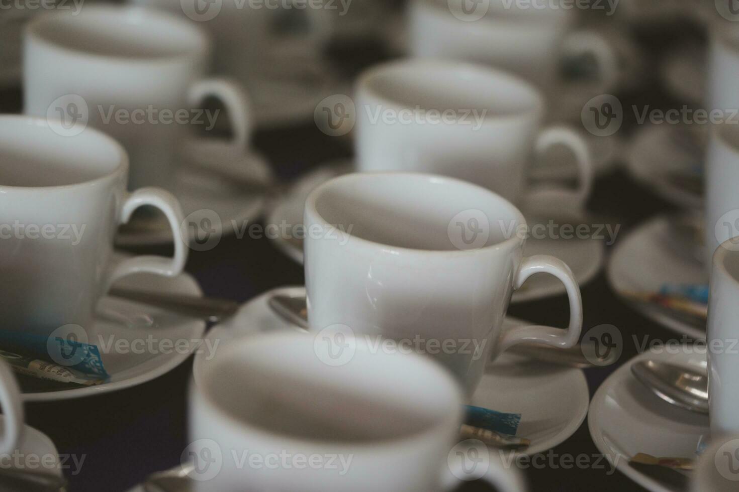 Many empty cups with spoons for service coffee in seminar event or meeting room photo