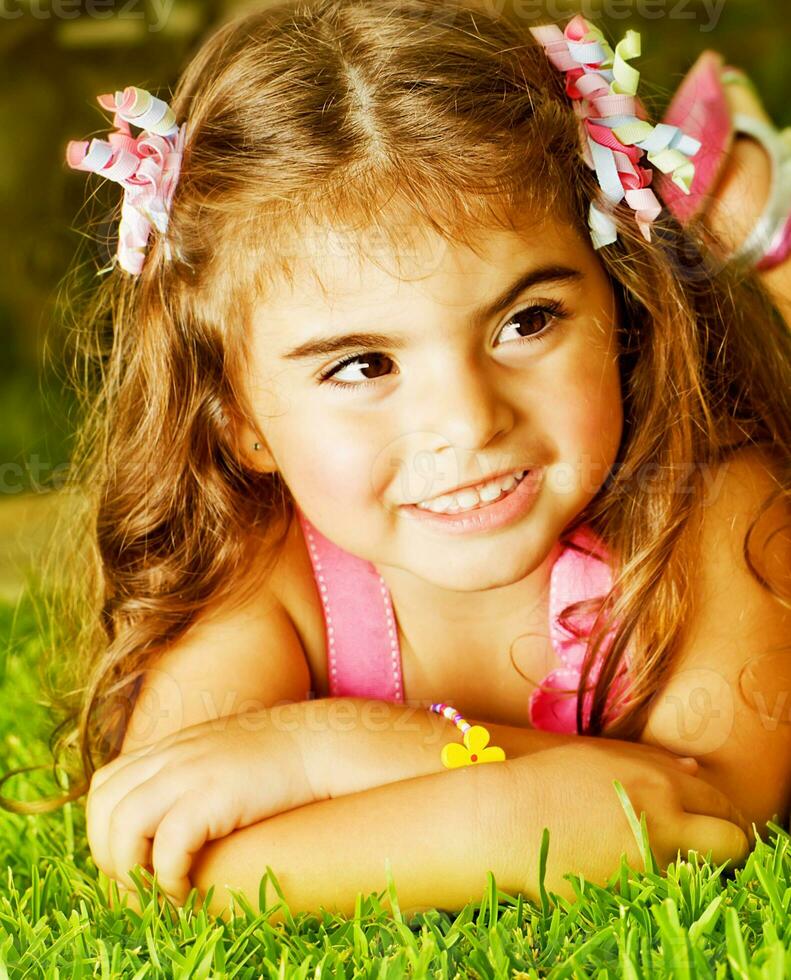 Little girl on green grass photo