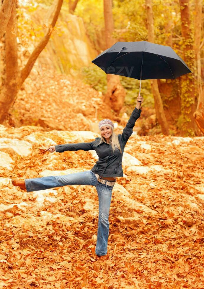 Sweet girl jumping with umbrella photo