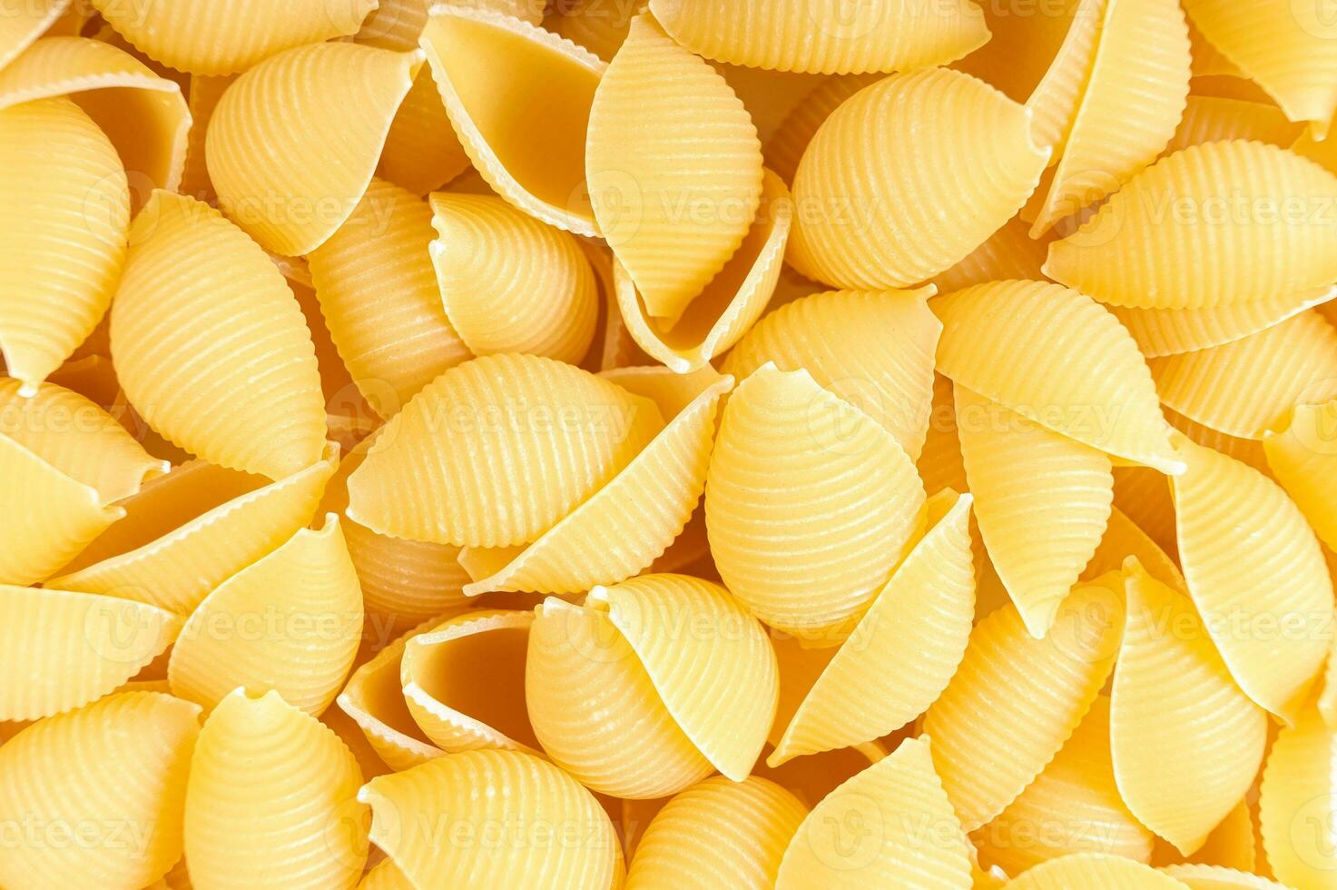 Raw pasta conchiglioni spaghetti pattern. Food background, italian cuisine photo