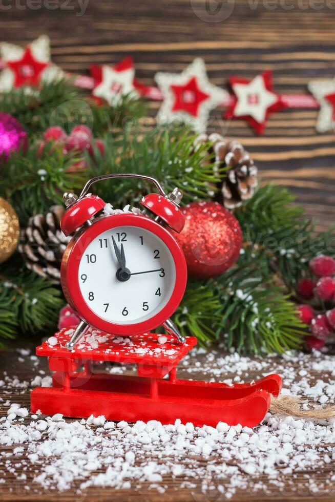 Alarm clock with snow and Christmas decorations photo