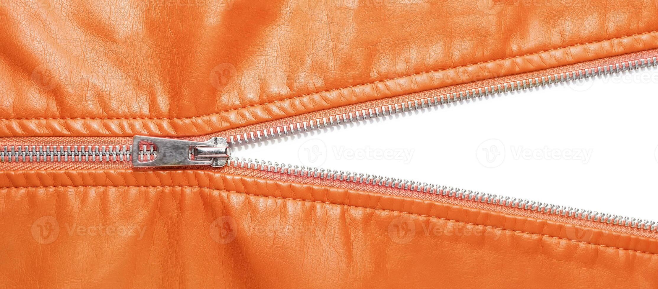 Orange leather texture and open metal zipper isolated on white background photo