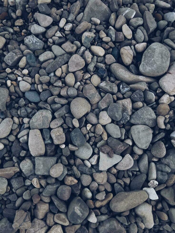 Stone pebbles of rounded fraction as a background texture photo