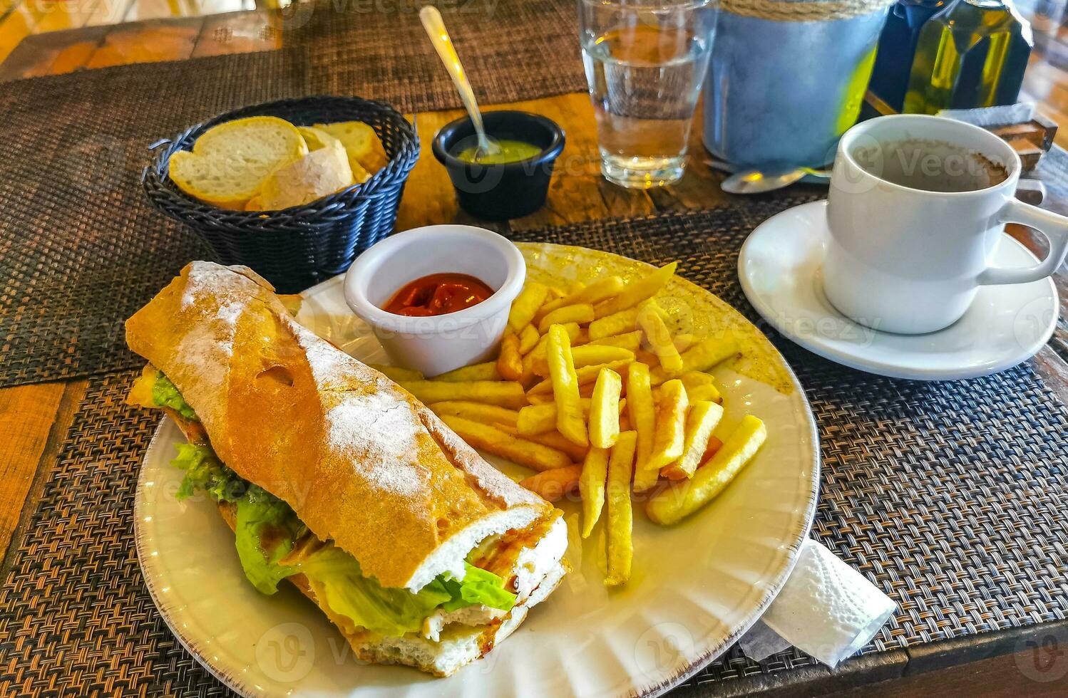 Baguette sandwich toast bread with chicken tomato salad potatoes fries. photo