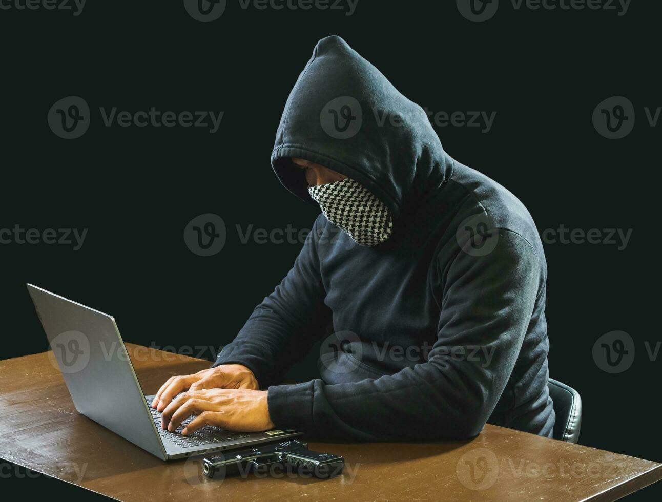 Portrait hacker spy man one person in black hoodie sitting on table looking computer laptop used login password attack security to data digital internet network system night dark background copy space photo