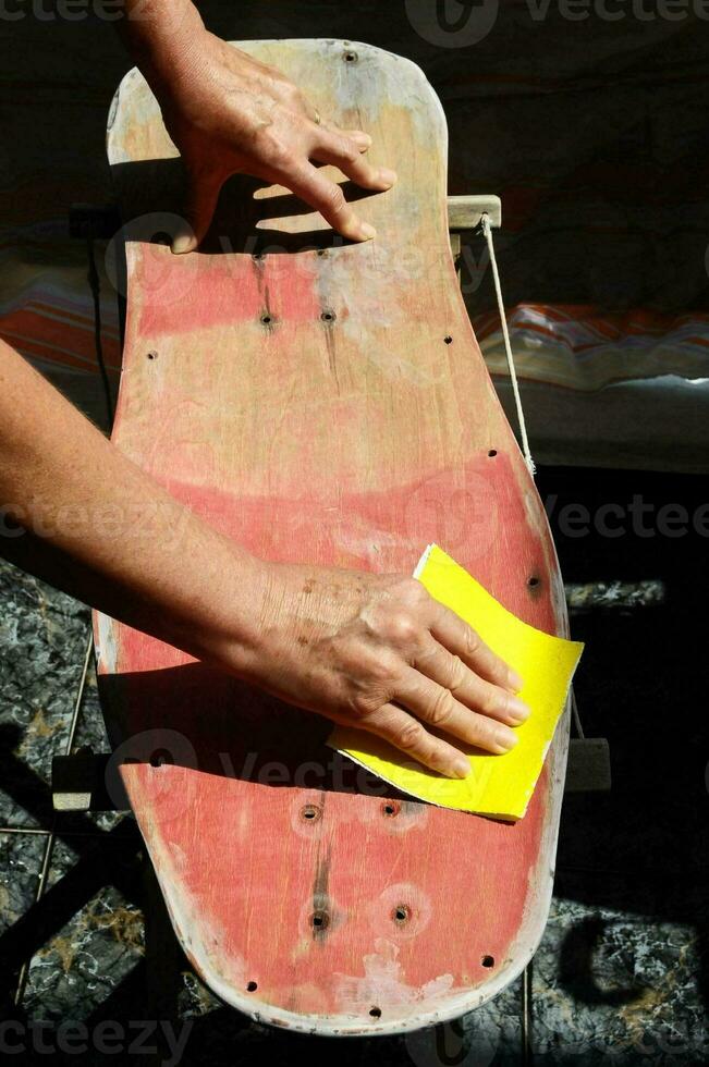 a person is sanding a skateboard photo