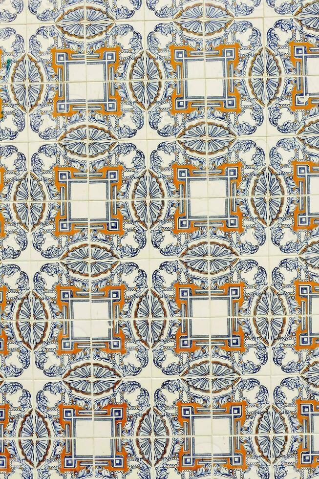 a close up of tile with a blue and orange design photo