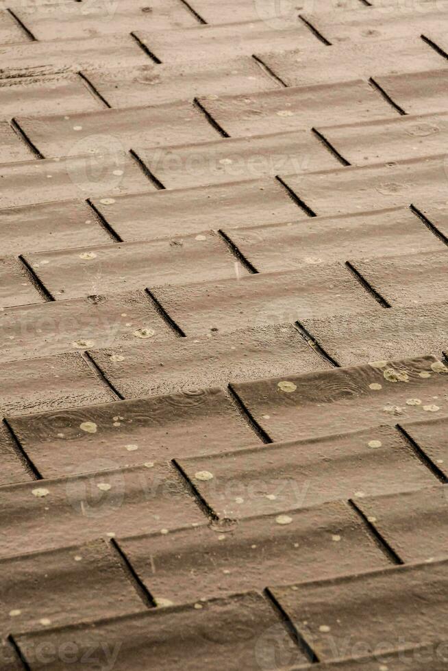 a close up of a roof with brown tiles photo