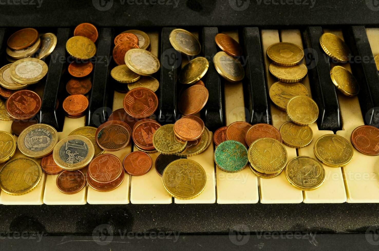 coins on the piano keyboard photo