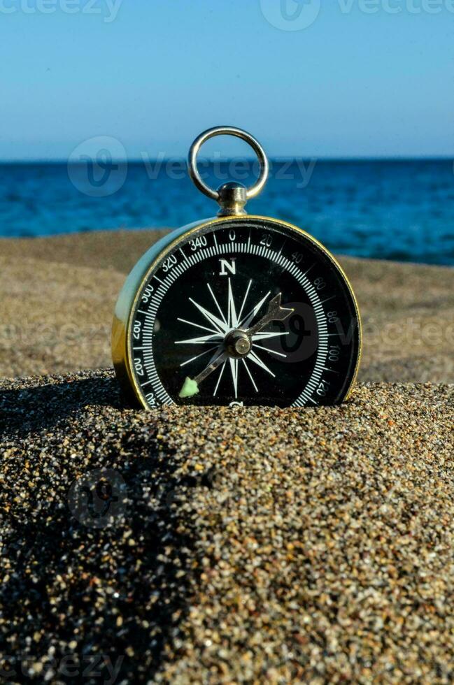 a compass on the beach photo