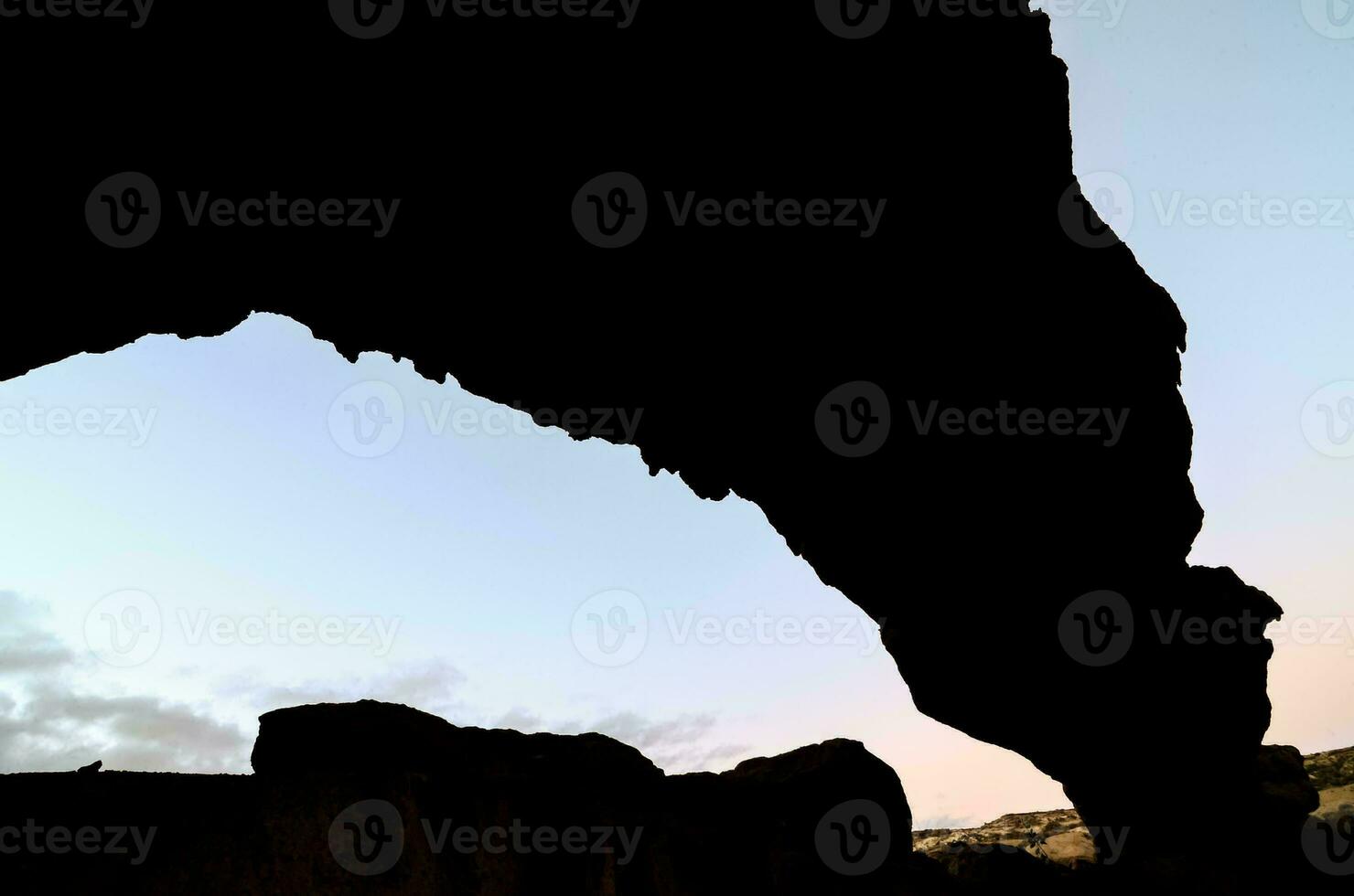 a silhouette of a rock formation photo