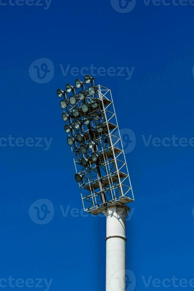 a stadium light against a blue sky photo