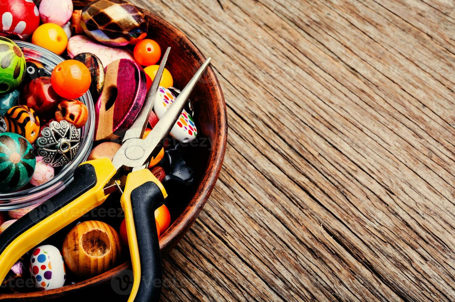 Colorful beads on a wooden surface photo