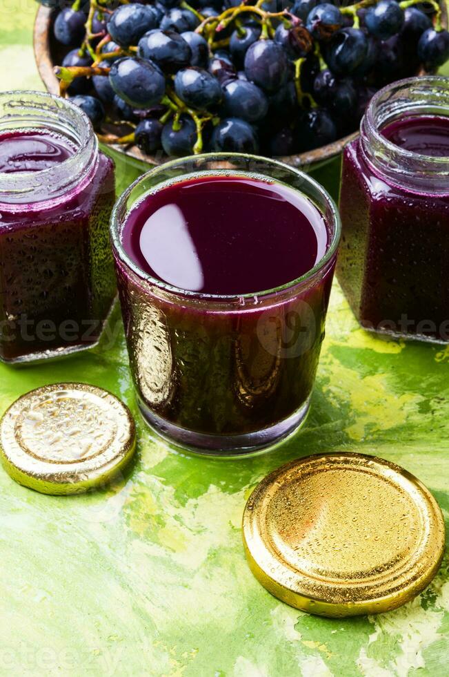 Red grape juice in glass photo