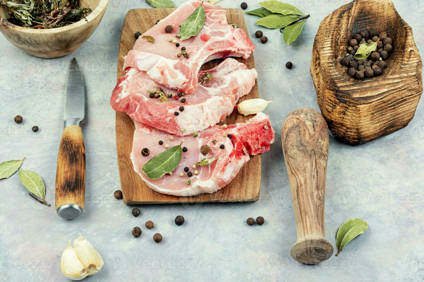 Raw pork steak on a wooden board. photo