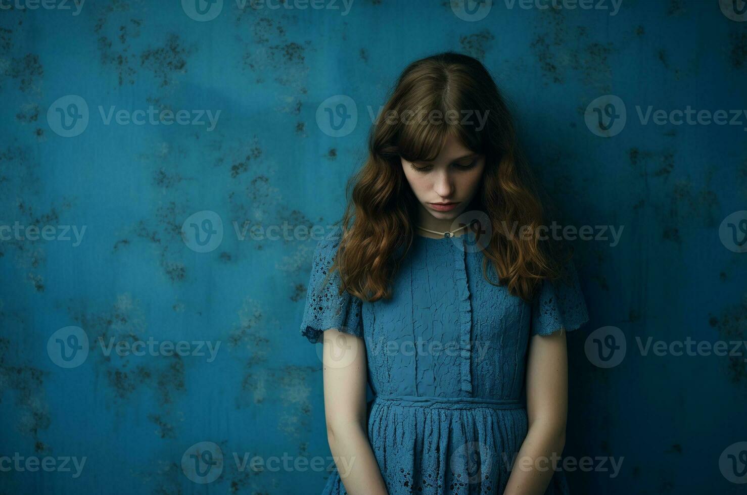 Blue Monday. Sad Monday. Girl with her head down in a blue dress on a blue background. Generative ai photo