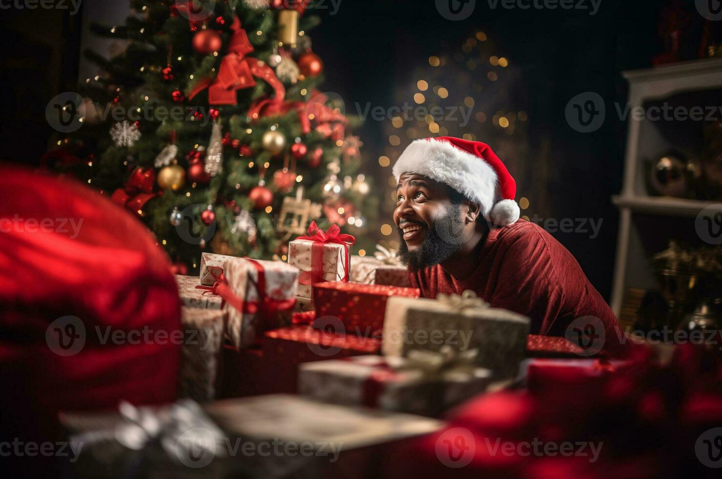 A black man in a santa hat sits near a Christmas tree in a mountain of gifts. Generative AI photo