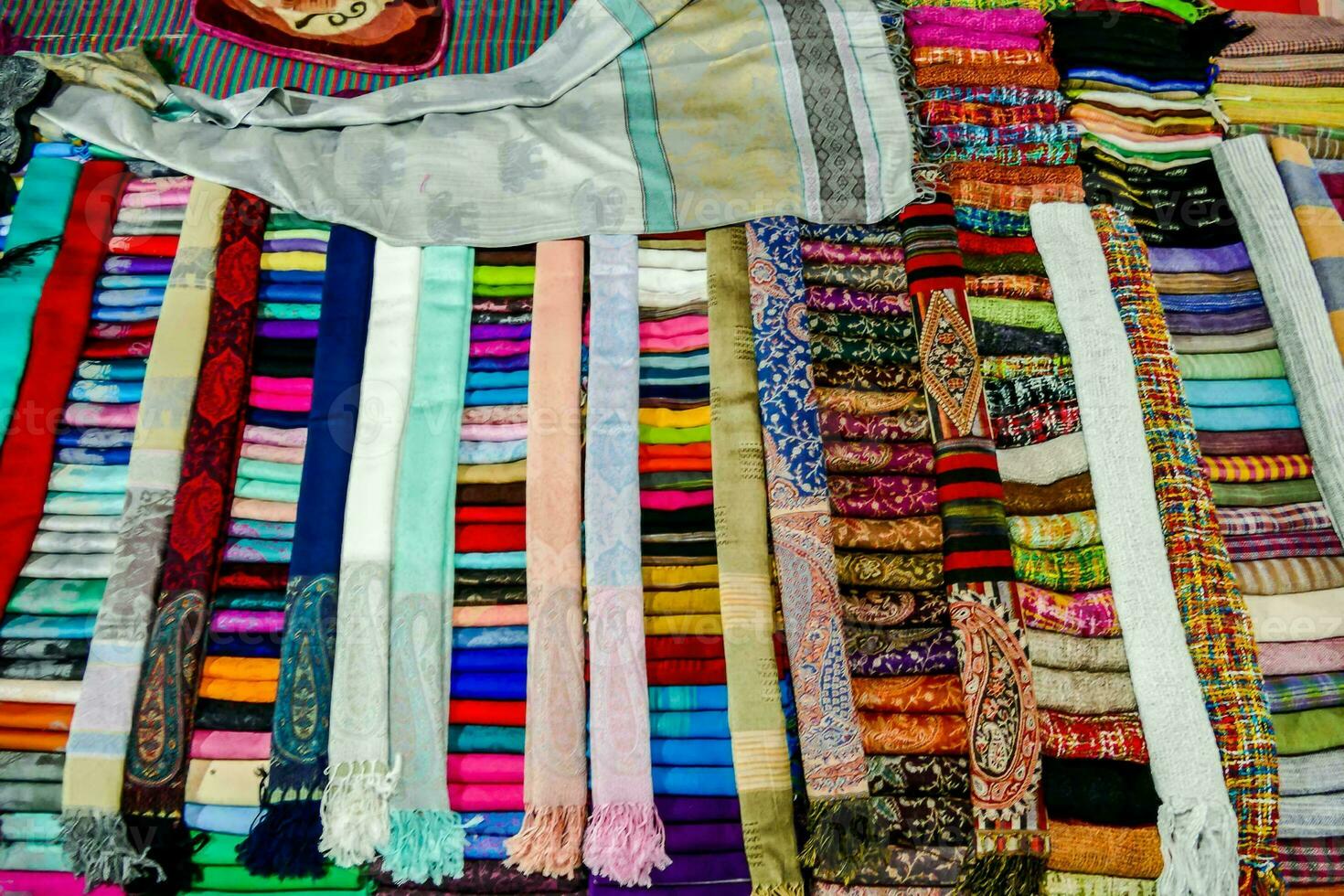 a pile of colorful scarves on display photo