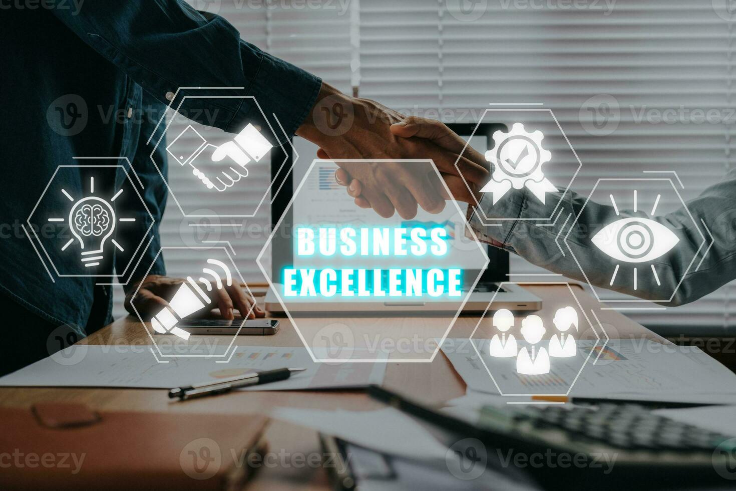 Business excellence concept, Business team making handshake with his partner in office desk with business excellence icon on virtual screen. photo