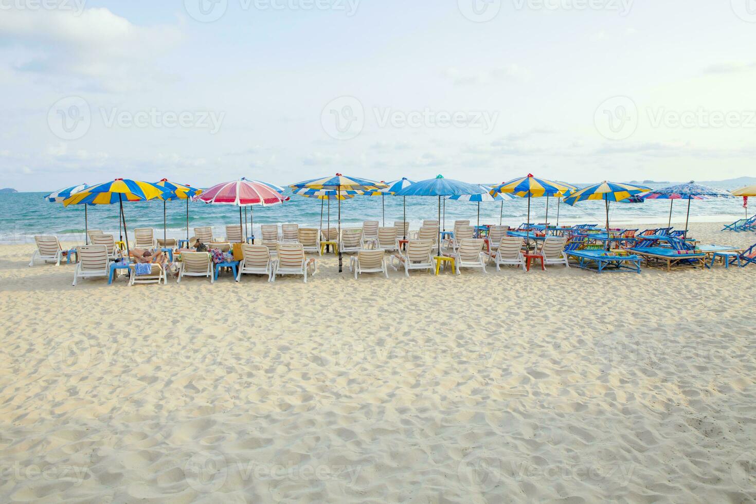 beach chairs and umbrellas on beautiful sea side place photo