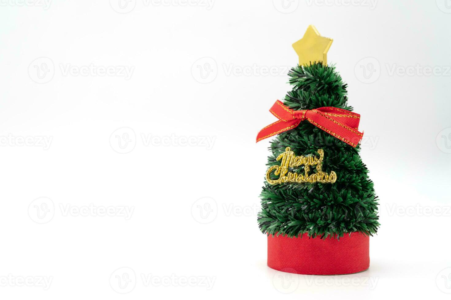 Little Christmas tree with red ribbon and text merry Christmas isolated on white background. photo