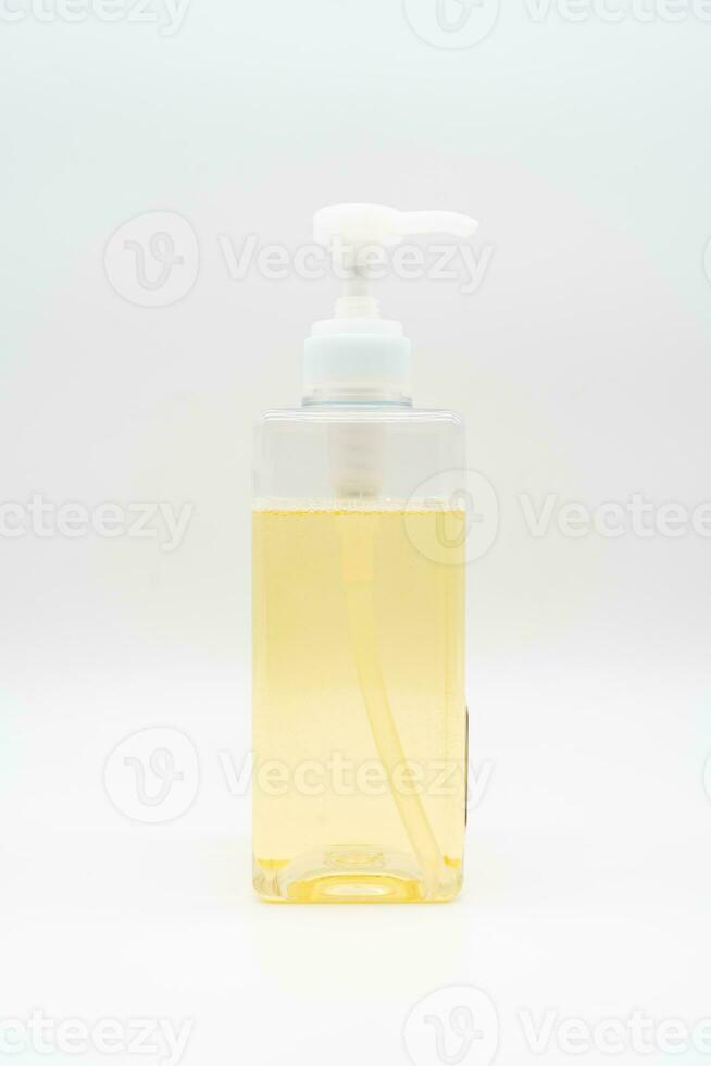 Yellow liquid soap or shampoo by pouring it from a refill to reduce plastic waste. Sustainable Zero Waste. photo