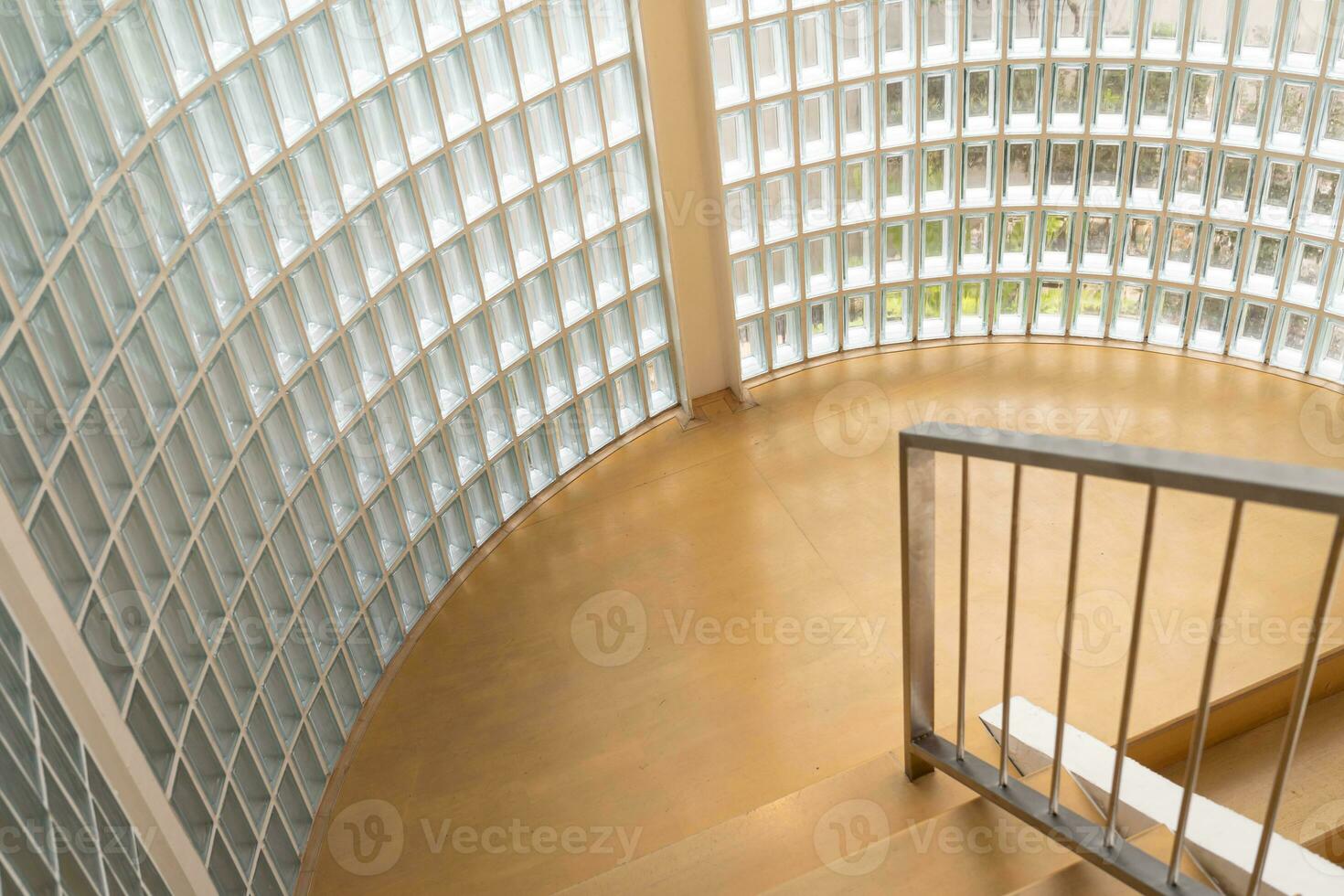 Glass blocks on the wall and wood floor. Wooden staircase and glass wall, interior design. photo