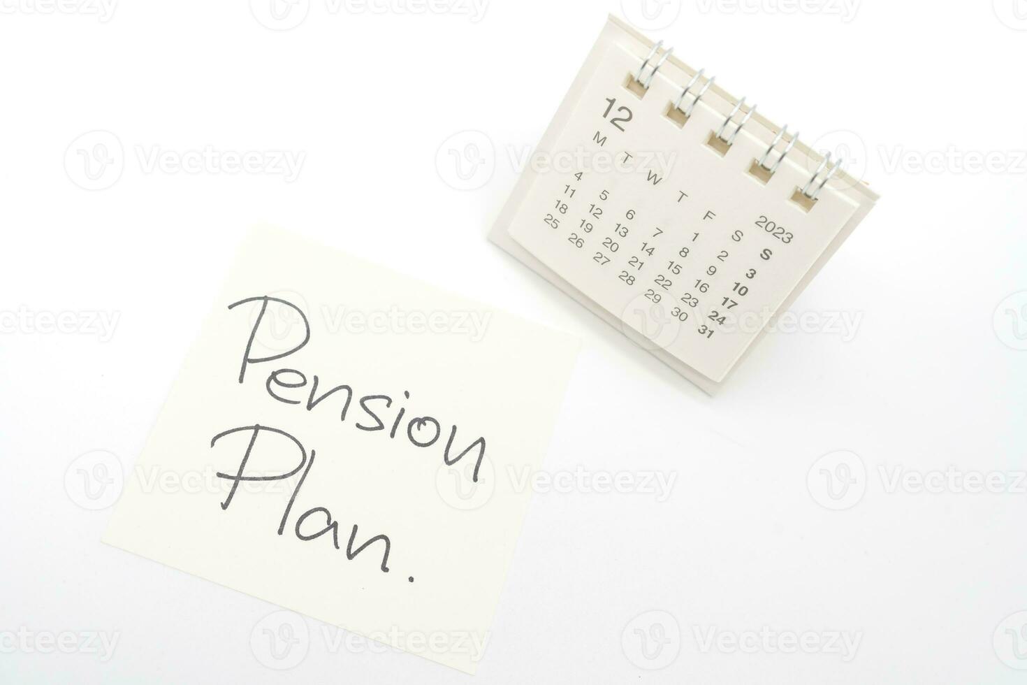 Desk calendar and Pension Plan Note Paper isolated on white background. For retirement, Pension Plan concept. Last date of work. photo